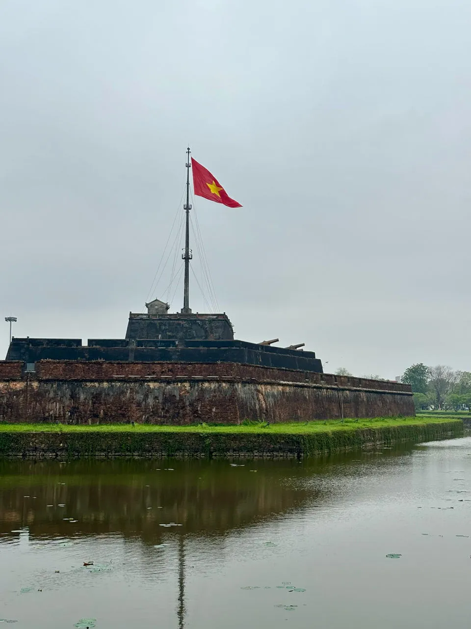 Vietnamese vlag wappert boven de vestingmuren van de Hue citadel